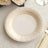 Elegant white plate with gold geometric pattern on a textured table setting.