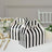 Black and white striped party favor boxes on a table setting.