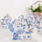 Floral-patterned teapot on a soft surface with blurred background