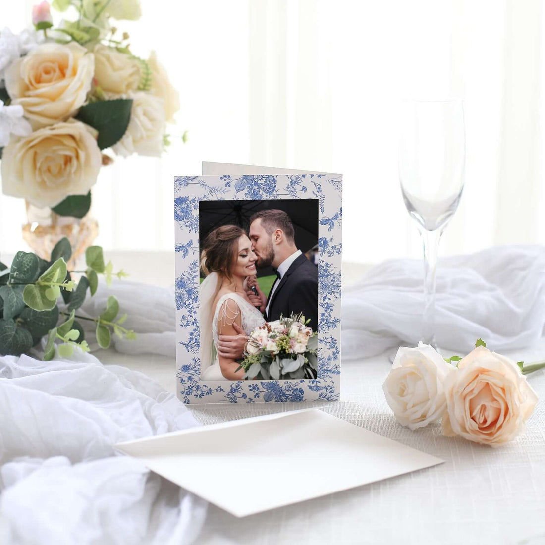 Wedding card with floral design featuring a couple embracing.