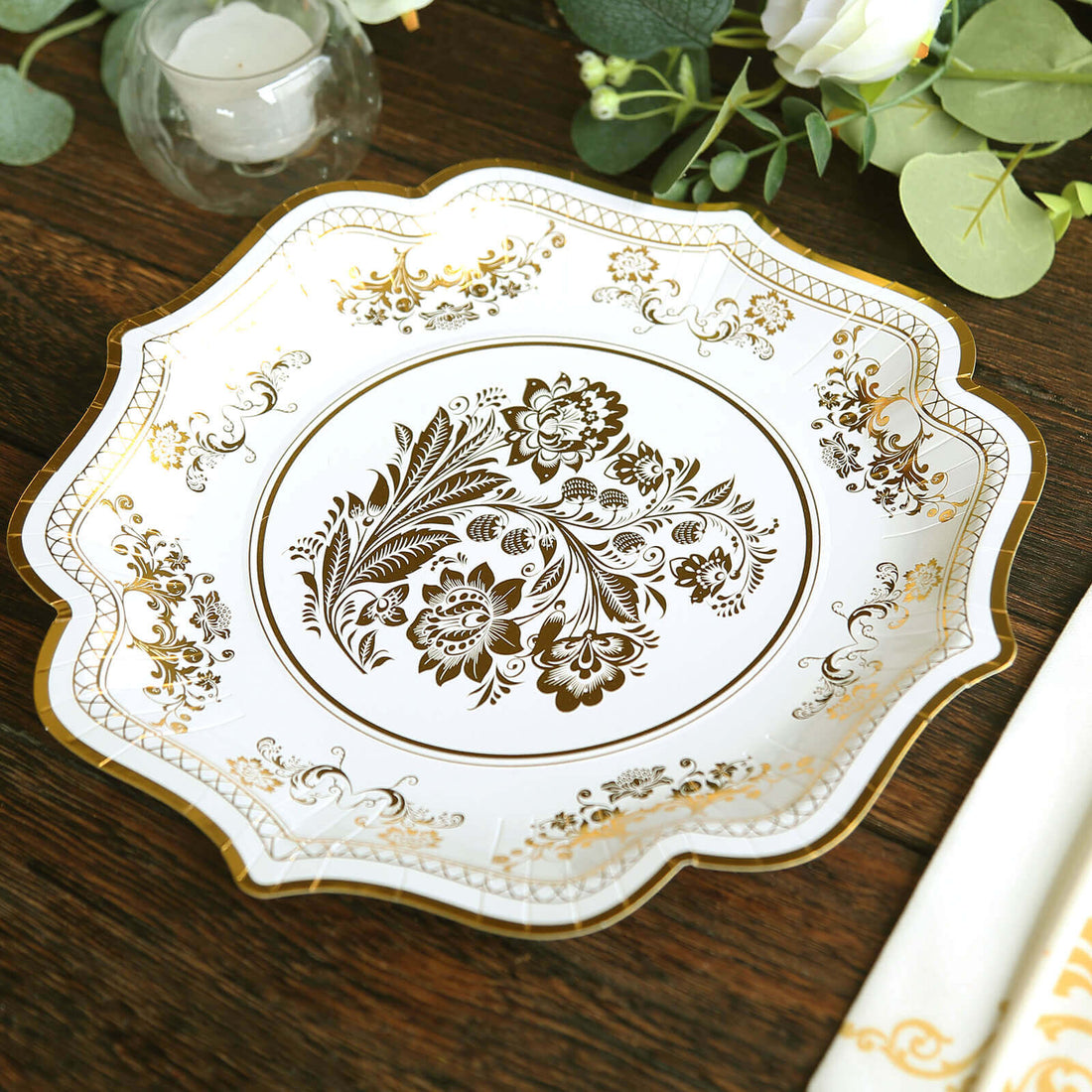 Elegant gold floral design plate on wooden table.