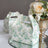 Decorative floral gift boxes on a table with a bouquet of roses.