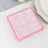 Pink floral-patterned napkins stacked on a table.