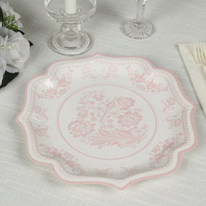 Elegant pink floral patterned plate on a textured table setting.