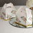Floral patterned gift boxes on a mirrored surface.