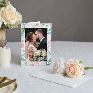 Wedding photo frame with floral design, featuring couple in romantic embrace.
