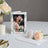Wedding photo frame with floral design, featuring couple in romantic embrace.