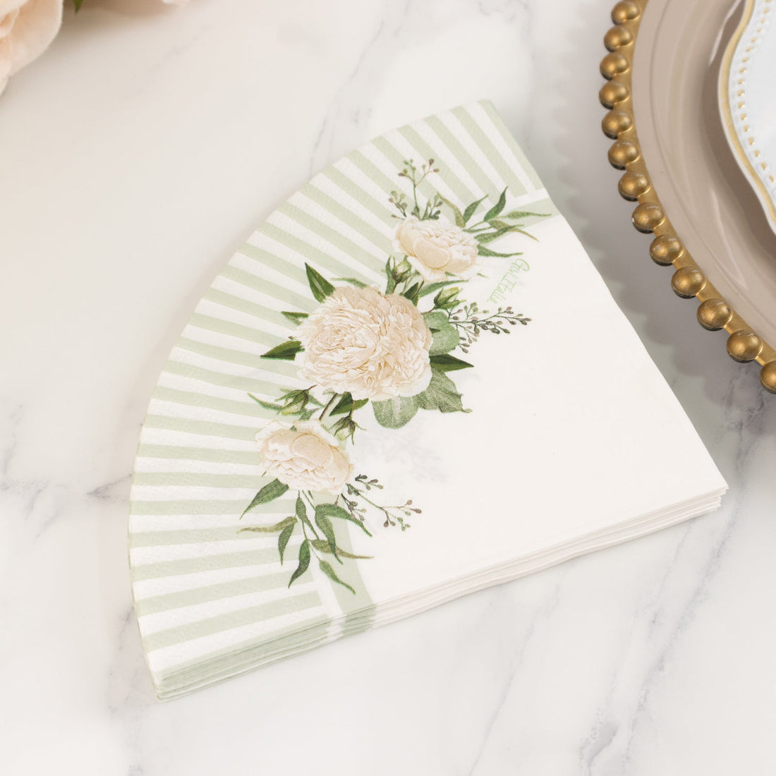Floral patterned paper napkin with green stripes and peony design.