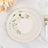 Elegant floral paper plates with striped design on marble surface.