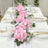 Pink floral table runner with elegant dinnerware and glassware set for a stylish dining experience.