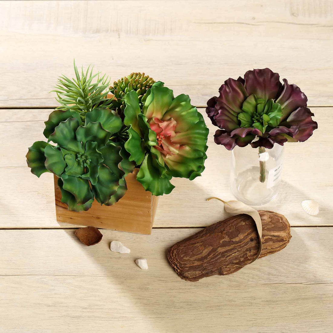 Artificial succulent arrangement in wooden box with decorative elements.