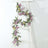 Colorful butterfly garland draped on a white ladder