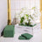 Artificial white flower arrangement in a rustic wooden box with green accents.