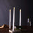 White LED candles with flame effect on a decorative holder.
