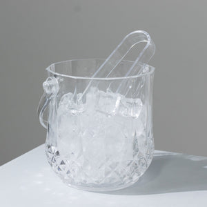 Crystal ice bucket with tongs and ice cubes inside