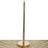 Gold paper towel holder on a decorative table surface.