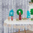 Colorful handmade wooden trees and decorations displayed on a table.