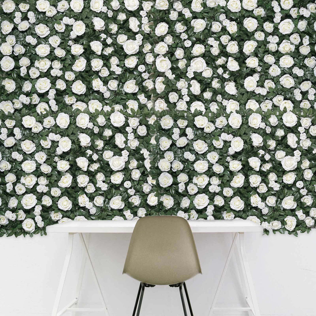 White rose floral wall mural with a modern chair in front.