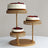 Three-tiered cake stand with white cakes topped with fresh berries.