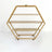 Gold hexagonal shelving unit with three shelves on wheels