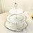 Three-tiered vintage cake stand with decorative edge.