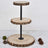 Three-tiered rustic wooden cake stand with metal support