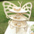 Butterfly-shaped cupcake stand with decorated cupcakes in a garden setting.