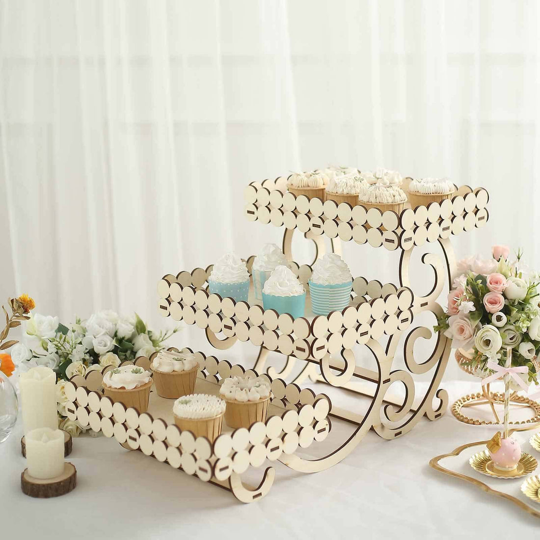 Wooden cupcake stand with decorative layers holding assorted cupcakes.
