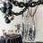 Decorative party setup with balloons, chains, and a dessert table.