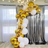 Gold and white balloon arch decoration for events and celebrations.