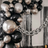 Black and silver balloon arch with a metallic chain decoration.