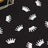 Silver crown confetti on a black background, ideal for party decorations.