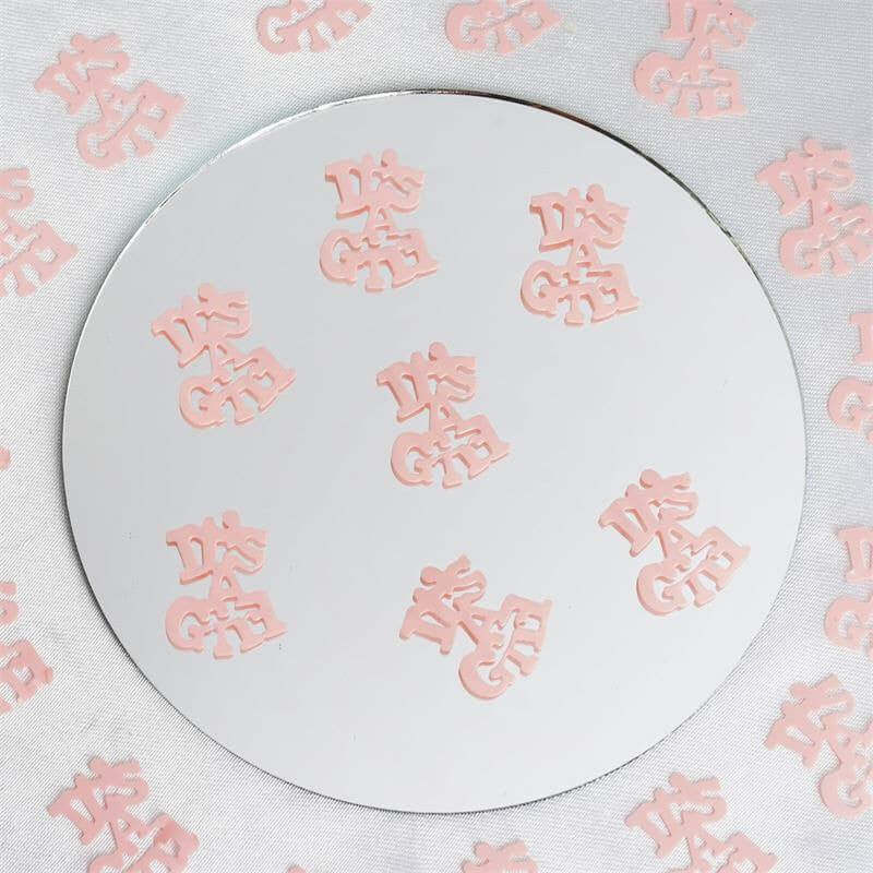 Pink logo stickers arranged on a circular mirror surface. #whtbkgd