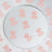 Pink logo stickers arranged on a circular mirror surface. #whtbkgd