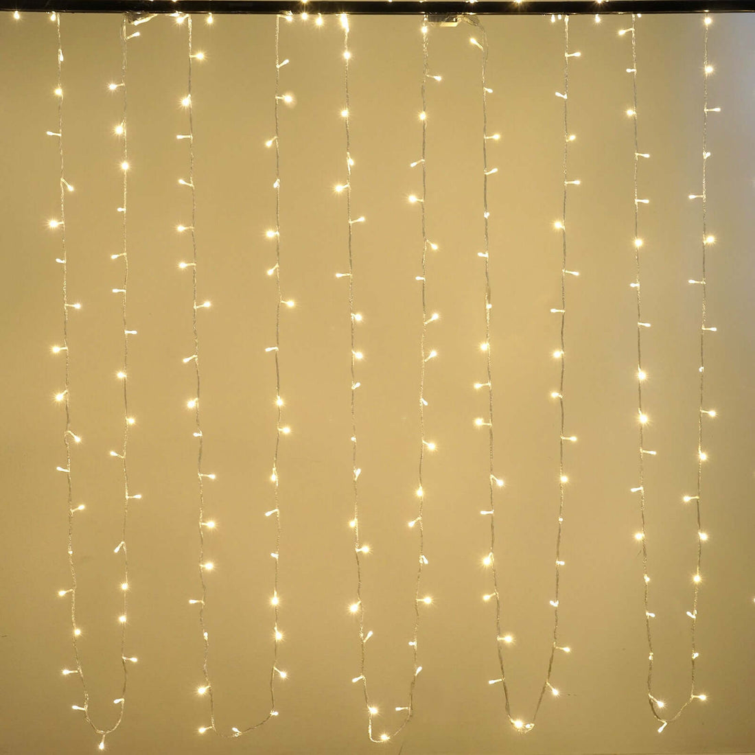 String lights hanging in strands, creating a warm ambiance. #whtbkgd