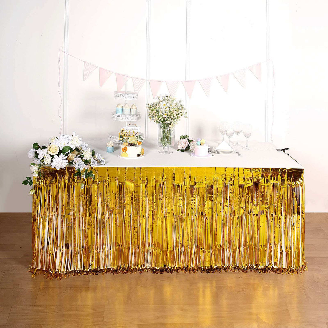 Gold fringe table skirt for party decorations, ideal for festive events.