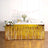 Gold fringe table skirt for party decorations, ideal for festive events.