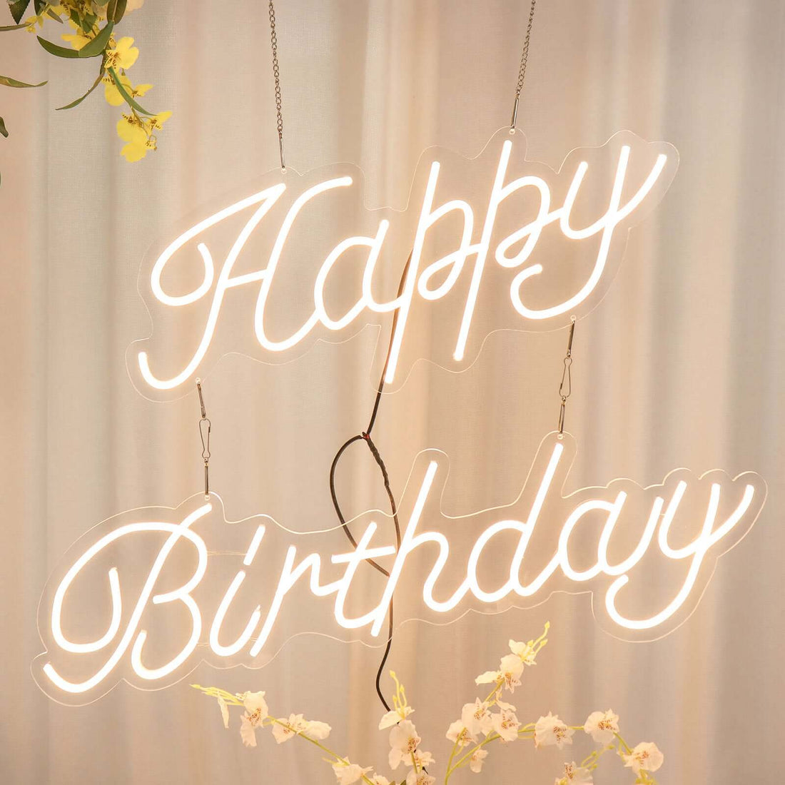 "Happy Birthday neon sign with floral accents"