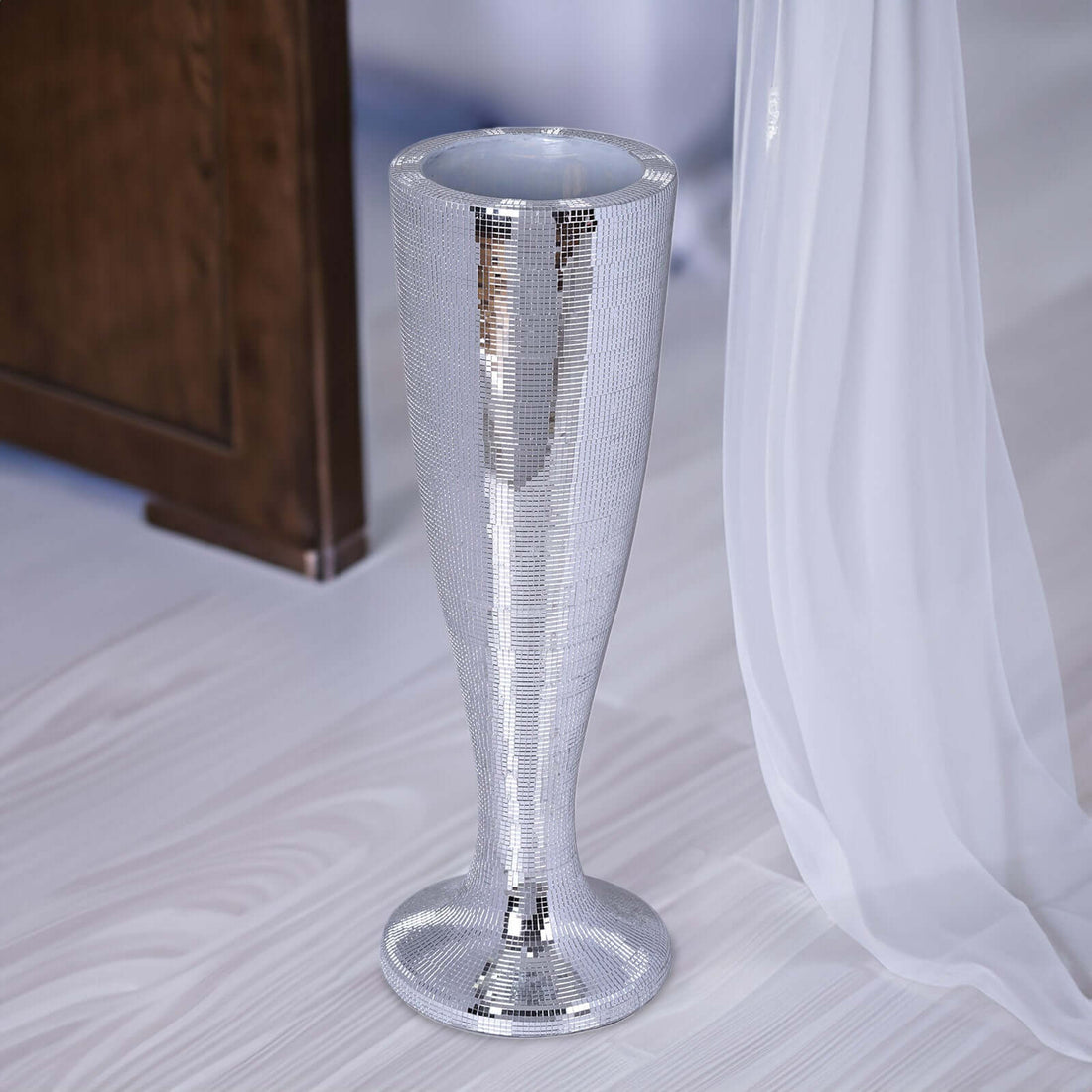 Silver disco vase with a sleek, modern design.