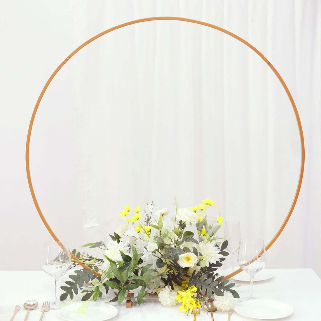 Floral centerpiece with circular frame for event decor.