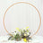 Floral centerpiece with circular frame for event decor.