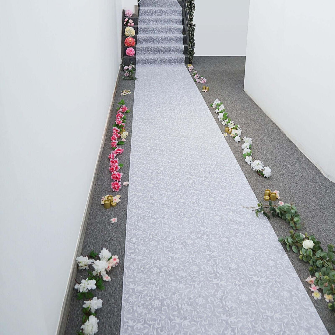 Decorative floral carpet runner on a staircase with flowers along the edges.