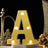 Illuminated letter A marquee light with gold decorative decor on black background