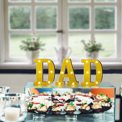 Lighted “DAD” sign on dessert table for Father’s Day celebration
