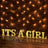 "It's a Girl marquee letters on a brick wall with string lights."
