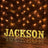 Light-up marquee letters spelling "JACKSON" against a brick wall background.
