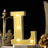 Yellow marquee letter "L" with lights on a decorative table setting.