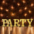 Illuminated marquee letters spelling "PARTY" against a rustic brick wall.