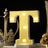 Yellow marquee letter 'T' with lights on a decorative table setting.