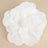 White flower decor piece with layered petals.